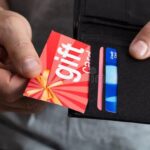 human hand removing gift card wallet close up human hand removing red gift card wallet 181269075