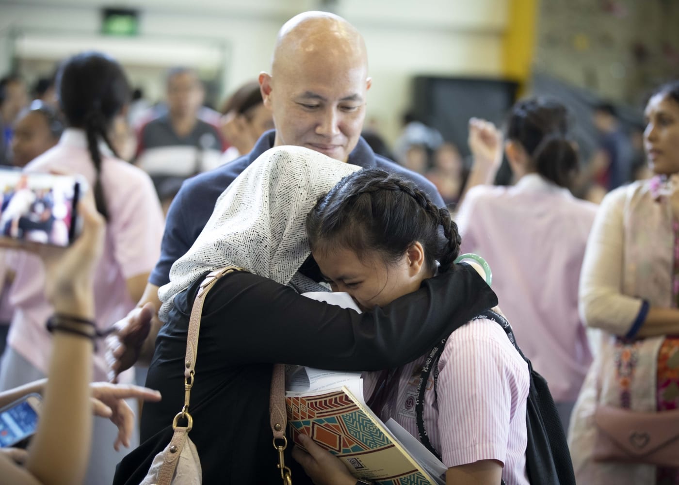 Family embracing after getting PSLE results