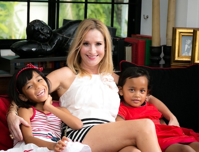 Sarah Salmon on the sofa with her daughters adopting babies in Asia