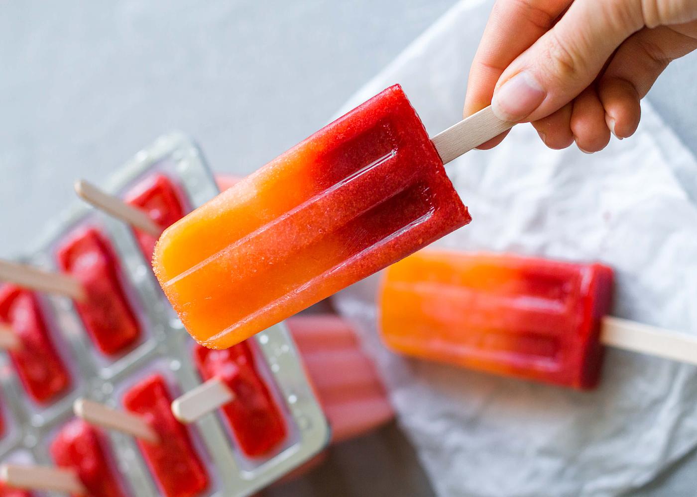 Orange strawberry sunrise popsicles by The Healthful Ideas