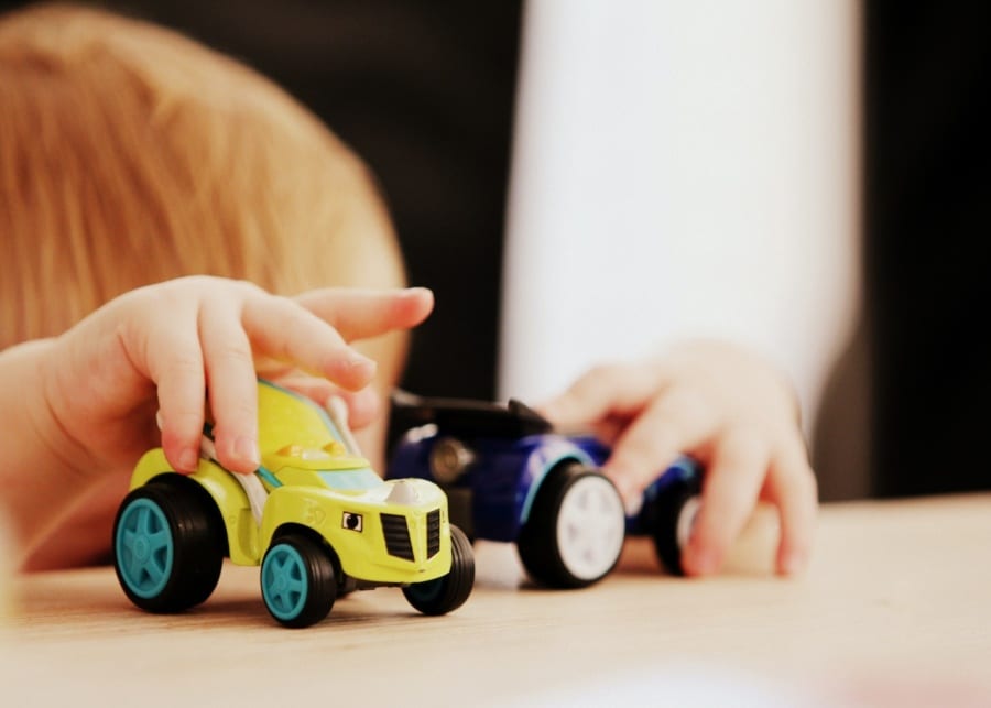 child playing with toy car