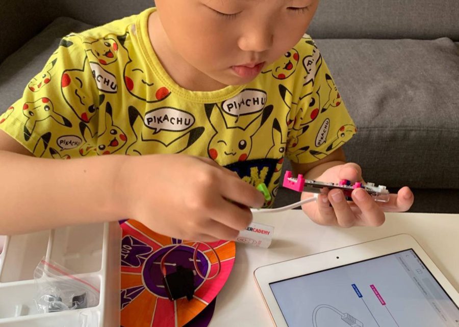 a boy playing with a stem toy