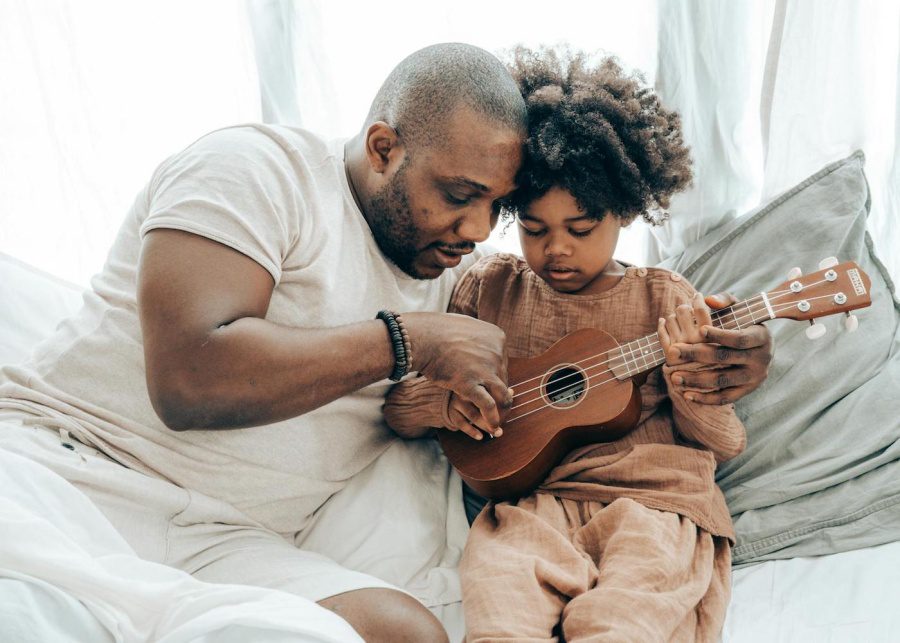 parent child father son play guitar bonding