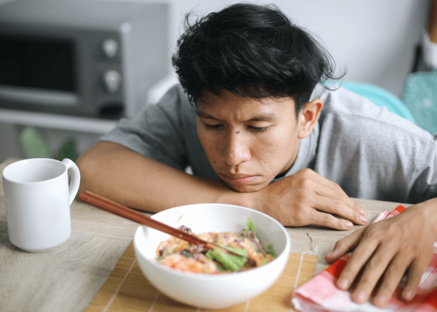 caregiver burnout man staring at food