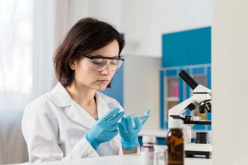 young female chemist wearing gloves 23 2148485914