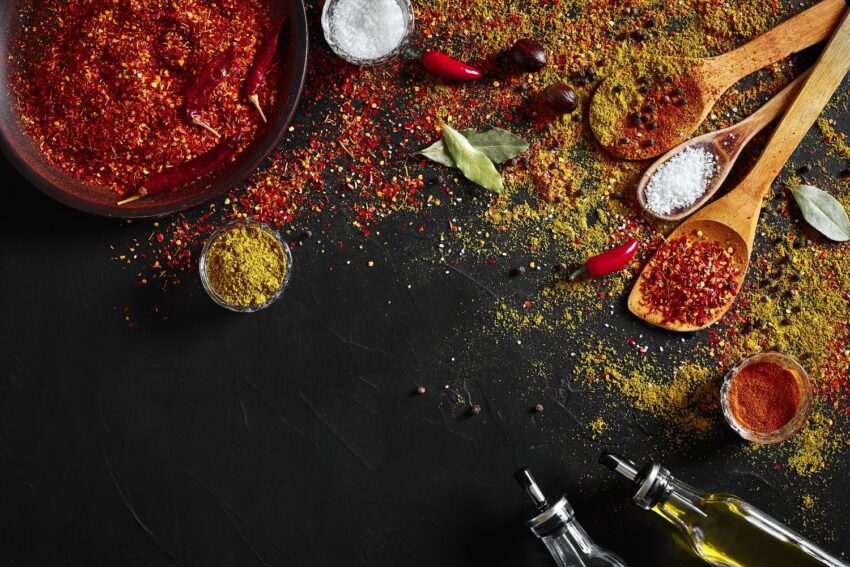 assorted spices dark black background seasonings food curry paprika pepper cardamom turmeric top view close up spices concept spices ingredients cooking 1