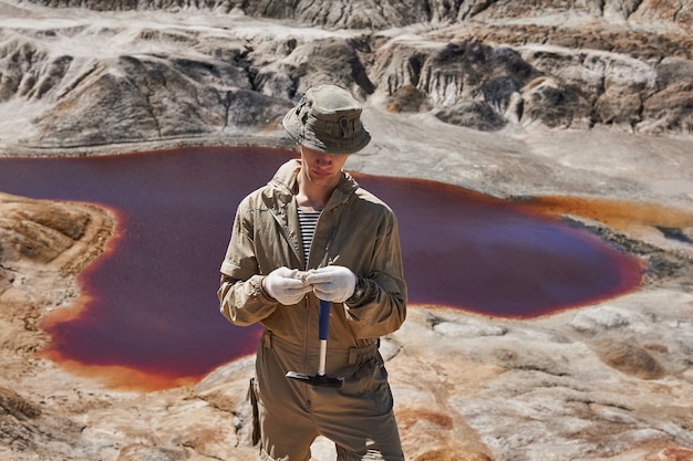 field expedition geologist examines sample mineral against canyon with salt lake 533998 4040