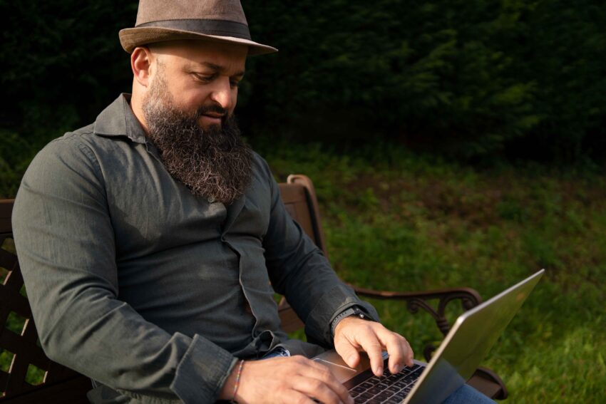 compressed side view man with laptop outdoors 1