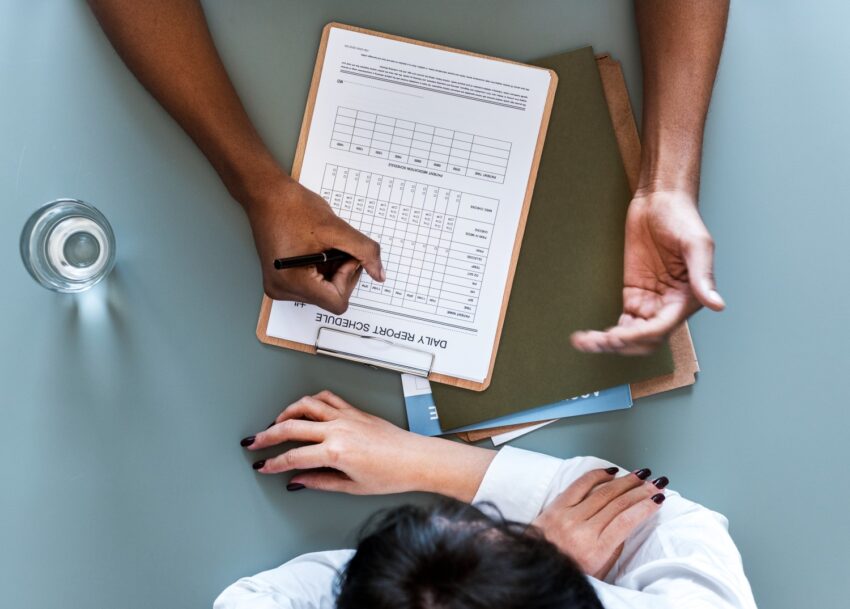 aerial view doctor writing patient daily report checklist 1