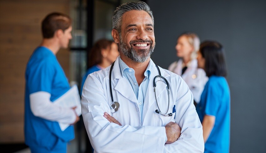 smiling middle aged indian doctor thinking and loo 2025 01 10 04 29 37 utc
