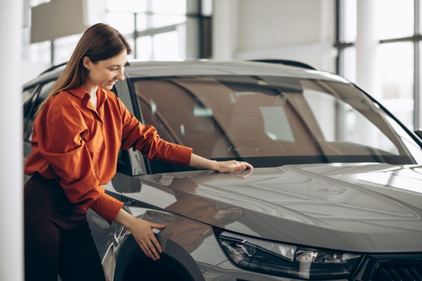 woman choosing car car showroom 1 1