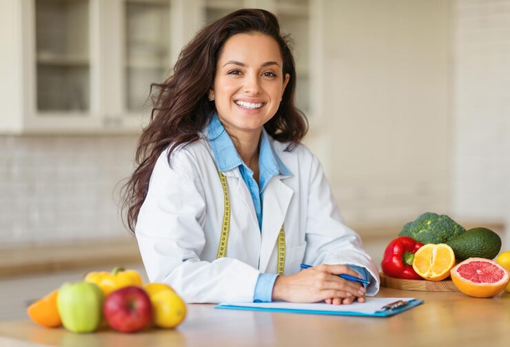 cheerful european woman doctor nutritionist white coat with organic fruits vegetables 116547 78050