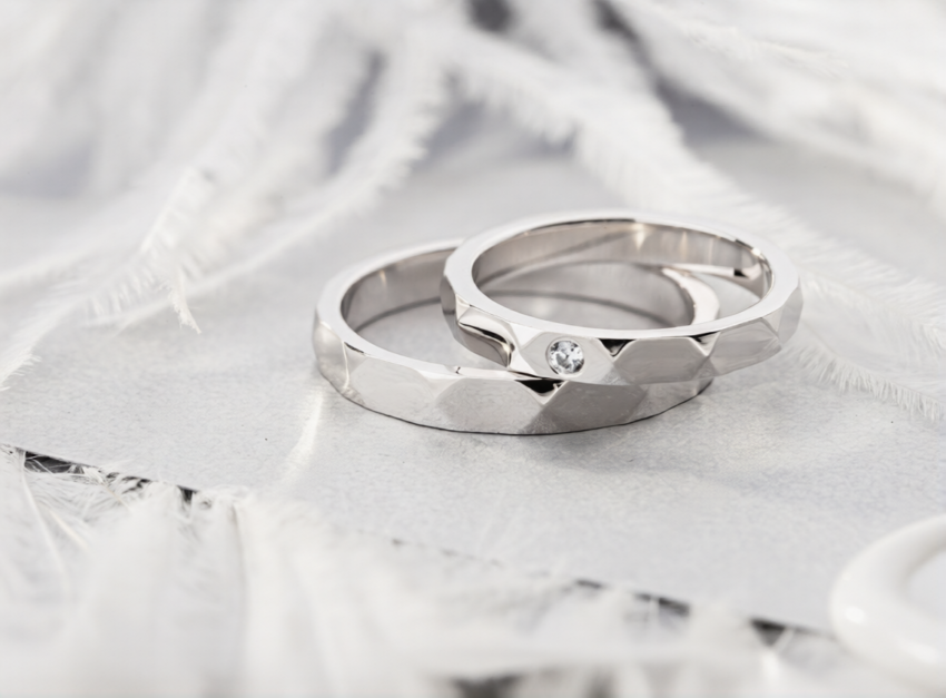 stock photo pair of silver wedding rings with diamond on gray background with feathers geometric shape wedding 1518001412 ezremove