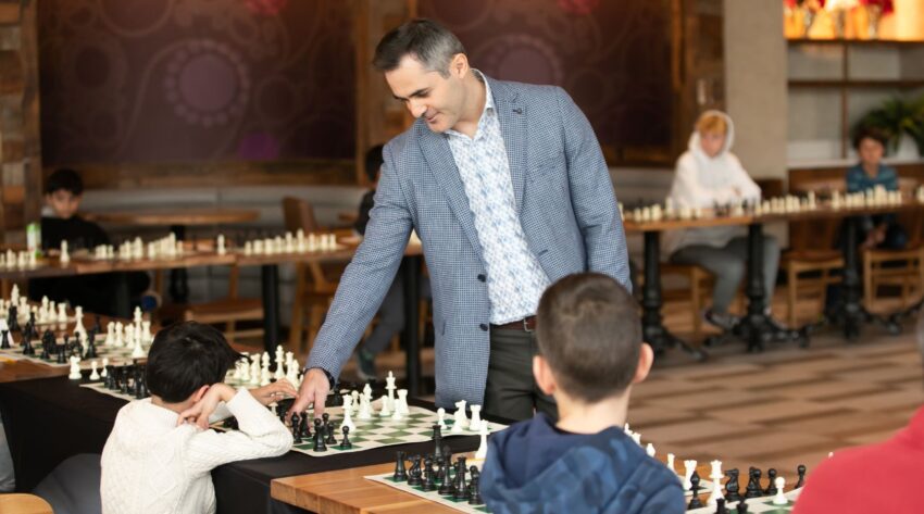 Grandmaster chess coach guiding young students