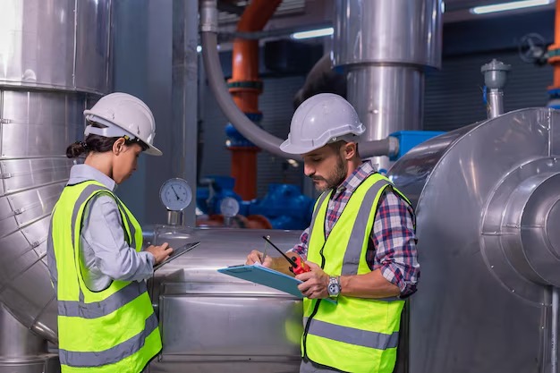 imgi 199 two workers are working factory with large pipe 978391 4227