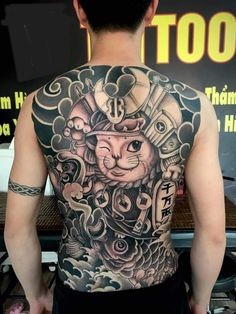 hình xăm mèo thần tài samurai kín lưng kết hợp họa tiết Nhật Bản đơn sắc Người đàn ông khoe hình xăm lớn trên lưng, thể hiện mèo thần tài và các chi tiết nghệ thuật khác.