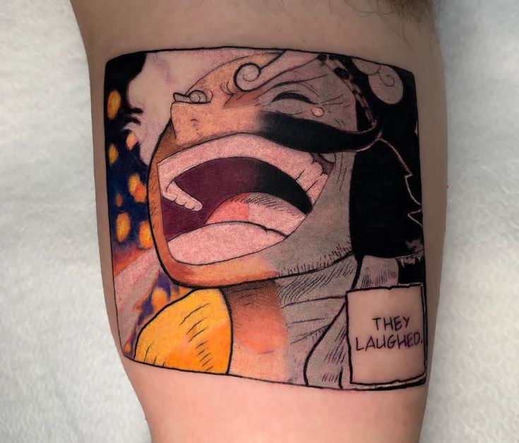 xăm mini hình vuông ở tay Hình xăm nhân vật hoạt hình đang cười lớn với bong bóng thoại "They laughed." trên nền da người.