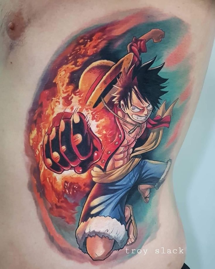 Mẫu xăm nhân vật Luffy đầy năng lượng Hình xăm trên cơ thể với hình ảnh nhân vật hoạt hình đang đấm lửa, mang phong cách mạnh mẽ và sống động.