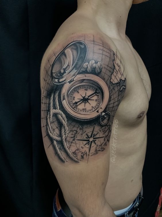 Hình xăm trên vai với la bàn, dây thừng và bản đồ, thiết kế chi tiết và phức tạp.